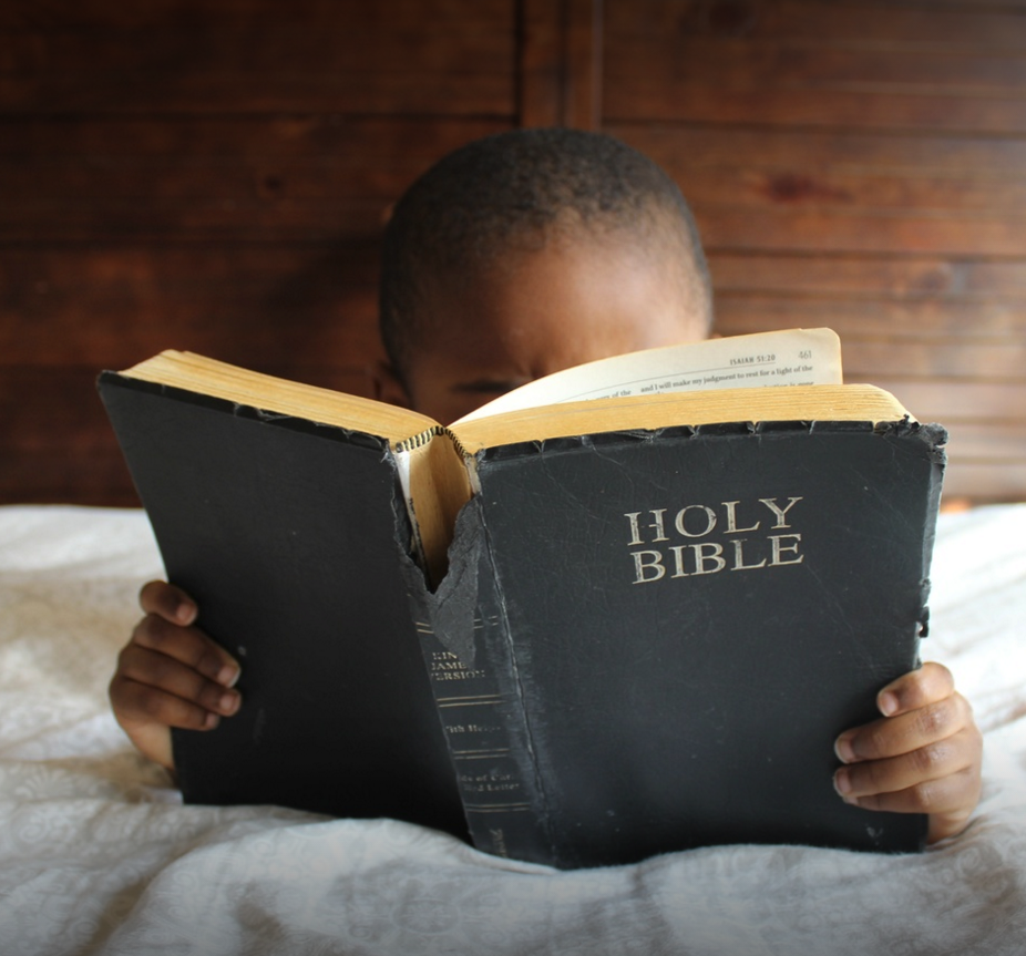 Child reading Bible